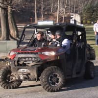 <p>First responders drive an ATV to remove the body of a man found in a state park.</p>
