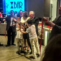 <p>Mayor Harry Rilling of Norwalk officially snips the ribbon for Bow Tie Cinema&#x27;s Grand (re)Opening.</p>