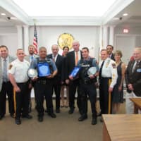 <p>P.O. Juan Rodriguez (holding awards, left) and P.O. John Rovetto are joined by the Fair Lawn Police administration, the mayor and council of Fair Lawn &amp; members of the Knights of Columbus St. Ann’s Council #2853.</p>