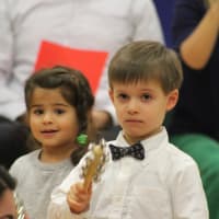 <p>Anika Hall and Aris Campos ring in holiday cheer with bells during the concert.</p>