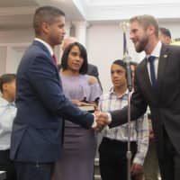 <p>Fair Lawn Mayor Kurt Peluso congratulating Officer Miguel Cruz after his swearing-in during the Borough Council meeting.</p>