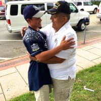 <p>Center fielder David Kleiman, 14, embraces his grandfather, Frank Rivera.</p>