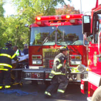 <p>Norwalk firefighters assist victims of the crash on the Route 7 connector Tuesday</p>