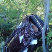 <p>A car flipped over the embankment and trapped two people inside on the Route 7 connector in Norwalk</p>