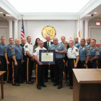 <p>Police Chief Glen Cauwels and Lt. Brian LaRosa hold the certificate of re-accreditation, joined by borough officers and municipal officials.</p>