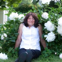 <p>Leslie Farhangi, founder of Three Meadows Spirits, surrounded by the Millerton peonies that inspired her.</p>