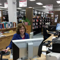 <p>Judy Silver on the reference desk at Paramus Public Library. Life goes on at the library until bids are reviewed prior to major renovation work.</p>