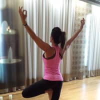 <p>Lucy Feaster, head of the yoga department, in a yoga studio at Life Time Athletic in Montvale.</p>