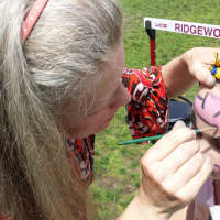 <p>Rowana Shepard paints the face of 7-year-old Brynn Michaelson.</p>