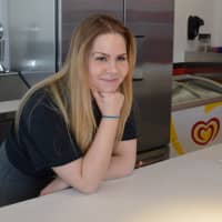 <p>Melissa Miller, manager, at the counter of Cherry Reds.</p>