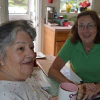<p>Catherine of Allendale, left, receives two meals from Pat Kehrberger, Community Meals volunteer.</p>