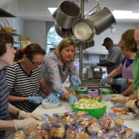 <p>Volunteers prepare meals at Christ Church that they will later deliver to the homes of people in Ridgewood and six other nearby towns.</p>