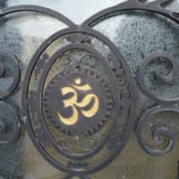 <p>Engraving of the &quot;Om&quot; symbol on the front door.</p>