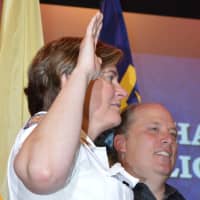 <p>Ridgewood Police Chief Jacqueline Luthcke takes her oath while standing next to her husband, Wayne</p>