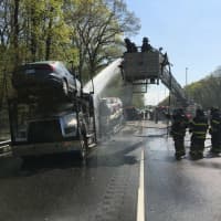 <p>Fire personnel put out a tractor-trailer car carrier fire on Interstate 95.</p>