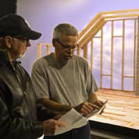 <p>Stamford TV producer Jeffrey Wyant and director James Hornbeck confer on the set of their infomercial for Lock &amp; Rollin Flooring Solutions.</p>
