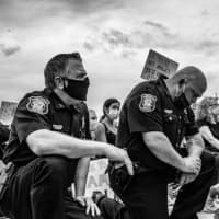 <p>Police officers kneel in solidarity during Friday&#x27;s Hoboken protest.</p>
