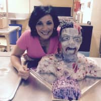 <p>Maria Galan of Wayne and a Halloween-themed cake.</p>