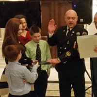 <p>Chris Sloma is sworn in as assistant fire chief on Sunday.</p>