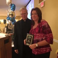 <p>Donna DiSclafani receives her plaque at the first St. Anne Hall of Fame dinner in Fair Lawn Oct. 23. </p>