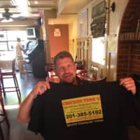 <p>A &quot;Screaming Sally&quot; contest winner shows off his T-shirt at Chicken Todd&#x27;s in Dumont.</p>