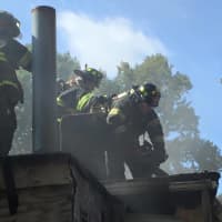 <p>Dumont Volunteer Fire Department members put down the blaze.</p>