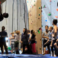 <p>Climbers encourage others to reach new heights.</p>