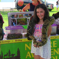 <p>A girl poses with a 10 foot snake at the Hudson Valley Expo</p>