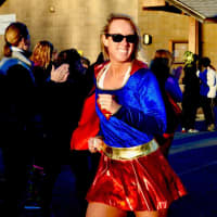 <p>Wallace doubles as superwoman at a Girls on the Run 5K race.</p>