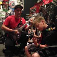 <p>Billy, 11, of Woodcliff Lake, plays guitar with his instructor, Dean, at School of Rock in Waldwick.</p>