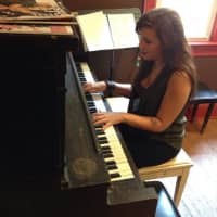 <p>Christina &quot;Alexa&quot; Houlis practices the piano at Cool Beans in Oradell.</p>