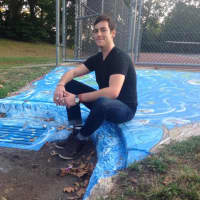 <p>Borough resident Keith Griffiths with his first piece of street art in Andreas Park, in Teaneck.</p>