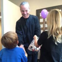 <p>Children donate their leftover Halloween candy to Dr. Archer Katz.</p>
