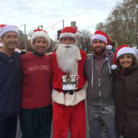 <p>Former Dumont runner Brian Lang, center, runs for and breaks a world record for a charity. </p>