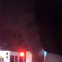 <p>Long Hill volunteer firefighters worked late Monday to put out a fire inside a tractor trailer and handle hazardous waste.</p>