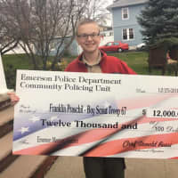 <p>The EPD presented a $12,000 check to Emerson Boy Scout Franklin Praschil, 15, who is bringing working on constructing a memory garden.</p>