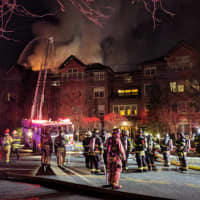 <p>A large fire burns at a condo complex at 100 Richards Ave. in Norwalk early Monday evening.</p>