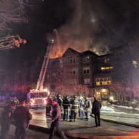 <p>Firefighters from Norwalk, Rowayton, Darien and Stamford battle a raging blaze at a condo complex at 100 Richards Ave. in Norwalk early Monday evening.</p>