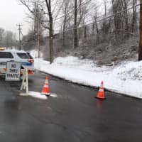 <p>A police car blocks Vale Road in Brookfield as repairs are made on a damaged utility pole.</p>