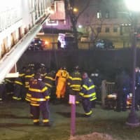 <p>The Norwalk Fire Department works to haul a car out of the Norwalk River early Sunday.</p>