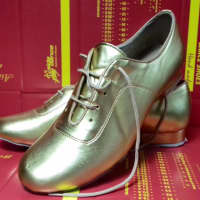 <p>These golden shoes were worn by Ram Viswanathan at the Millennium Dancesport Championships.</p>