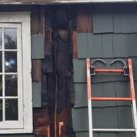 <p>Greenwich firefighters douse a small blaze inside a wall at this home on Cat Rock Road.</p>