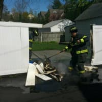 <p>The Greenwich Fire Department tackles a fence blaze on Thursday.</p>