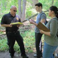 <p>New Rochelle police officers assisted students in Scott Rubins&#x27; forensics class.</p>