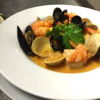 <p>Mariscada dish at Ibiza in Danbury (shrimp, sea scallops, mussels, little neck clams, coconut and saffron broth).</p>
