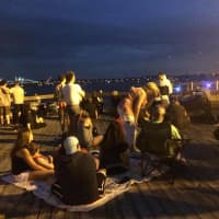 <p>A crowd gathers patiently awaiting fireworks as seen from the dock at the end of Main Street, Nyack.</p>