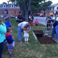 <p>A little girl gives Firefighter Chris Johnson after he saved her My Little Pony from a storm drain.</p>