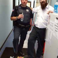 <p>Rabbi Lerman delivers cases of water to the Rutherford Police Department.</p>