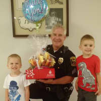 <p>Two young residents deliver a thank you gift to the Monroe Police Department in light of the Dallas police shootings.</p>