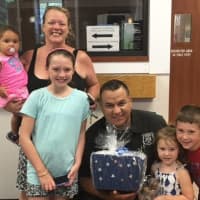 <p>Local Ramapo residents show their appreciation for a Ramapo police officer as part of the Blue Wave Shore to Shore Appreciation Week.</p>